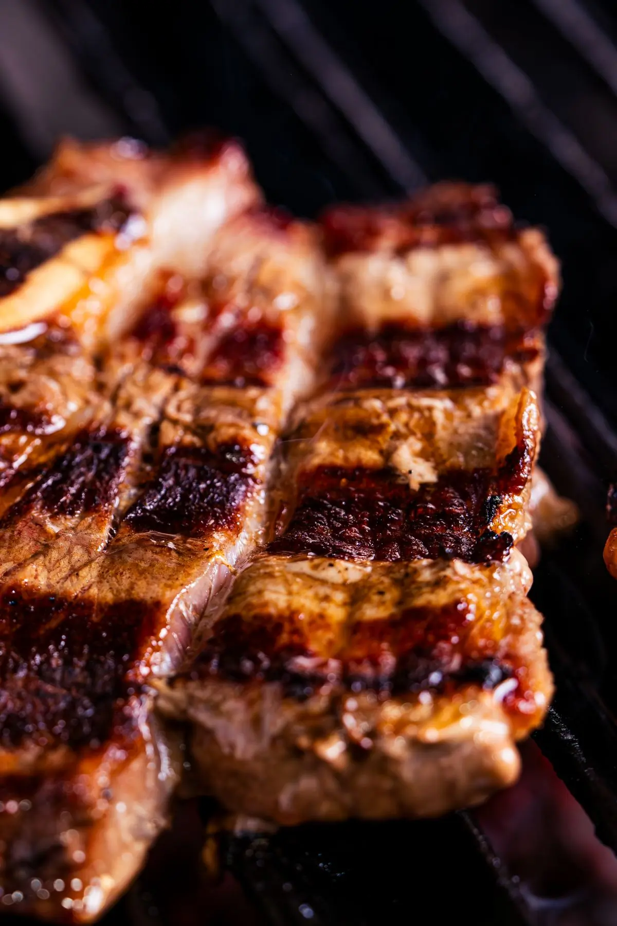 Pork chops charring over an open grill
