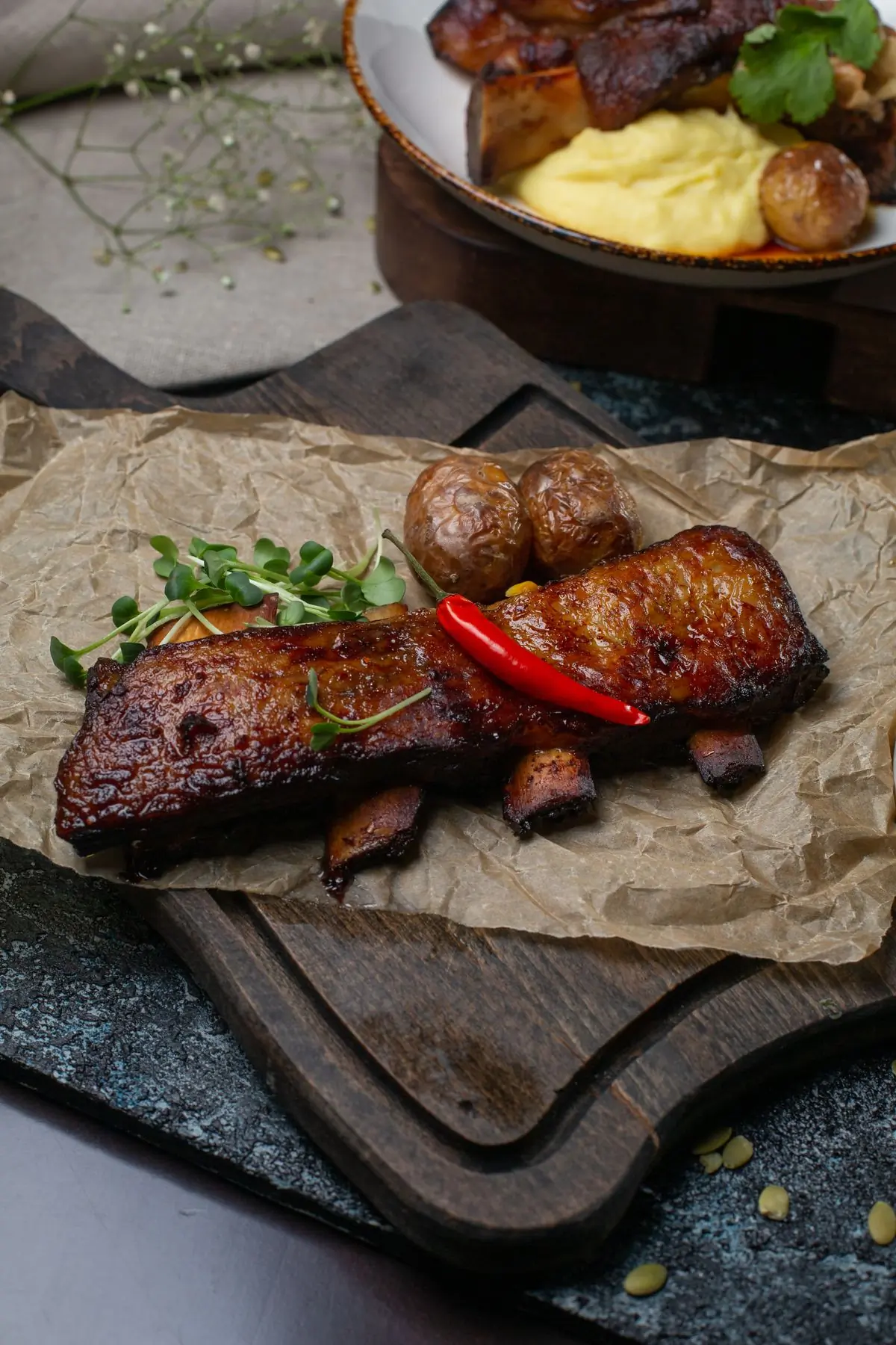 A rib roast carved and served with potatoes