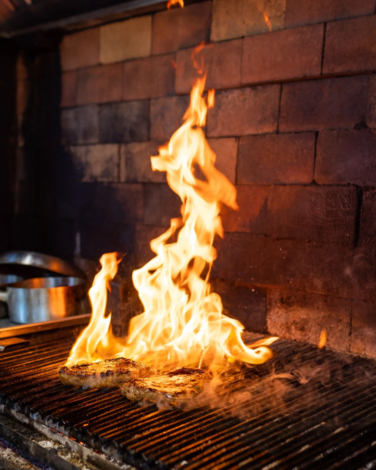 Wood burning down to coals in the pit