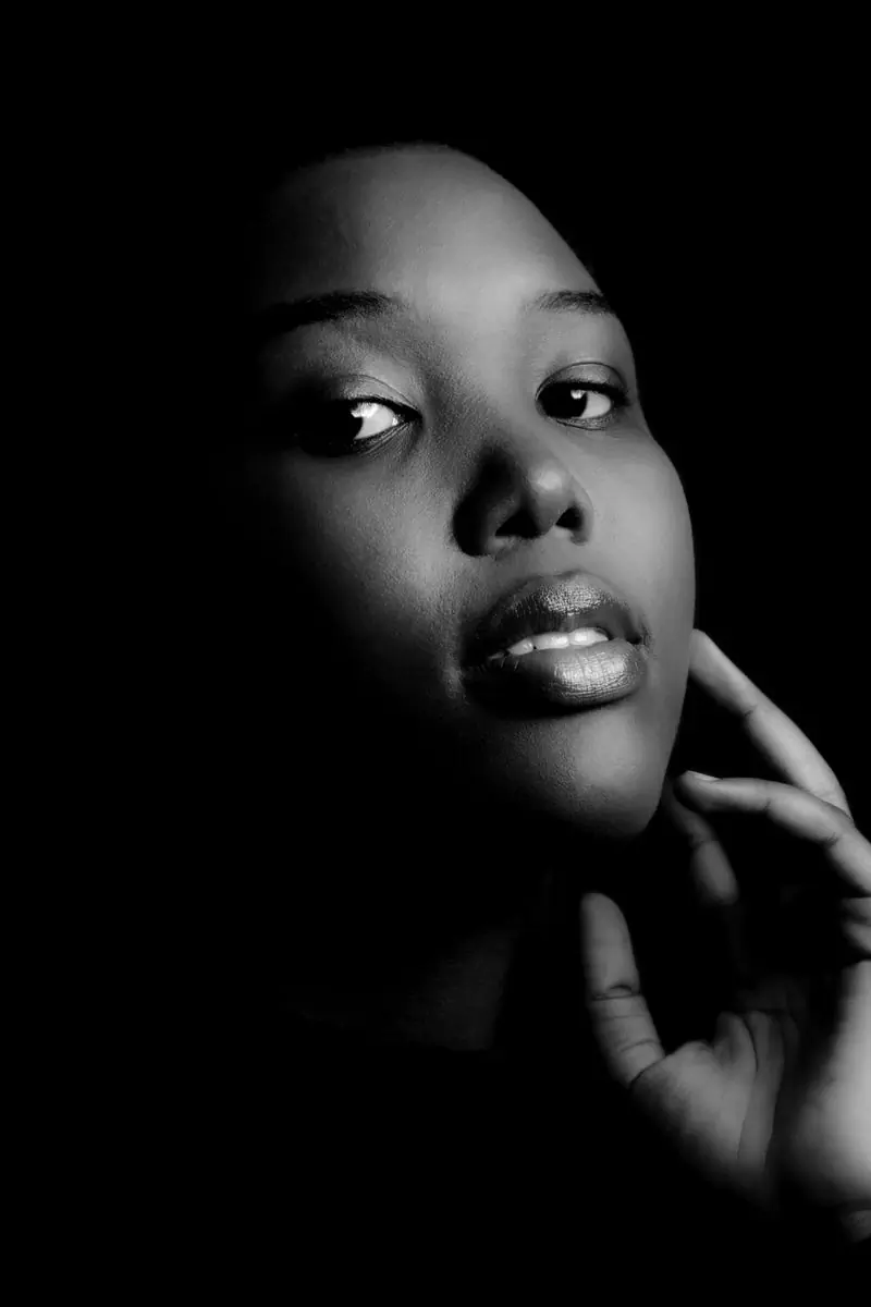 Ama Owusu-Brempong, a guest, photographed against a dark ground