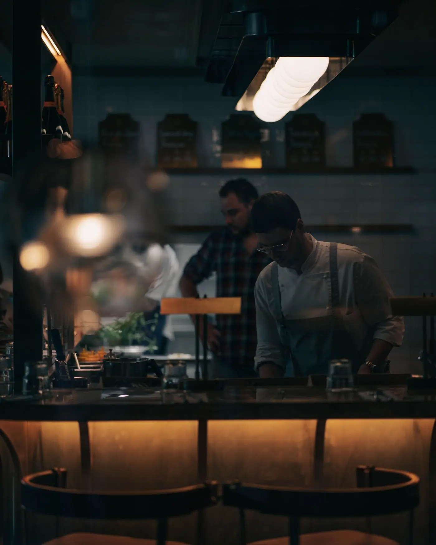 The kitchen pass at service, lit from above