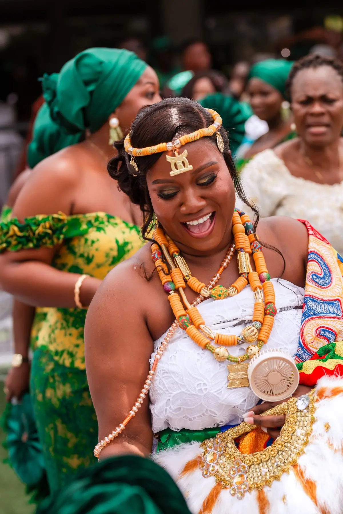 A guest in vibrant traditional dress celebrating at a wedding