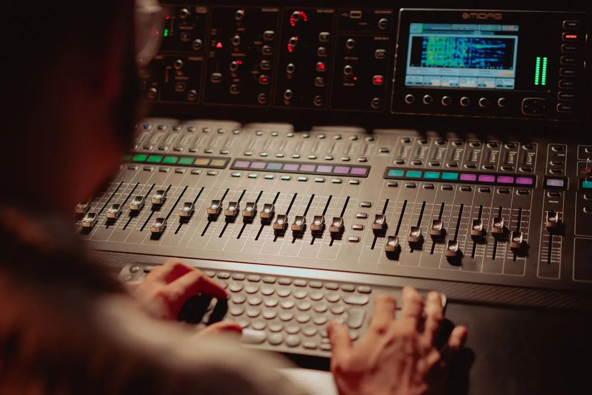 A sound engineer working at a digital mixing console