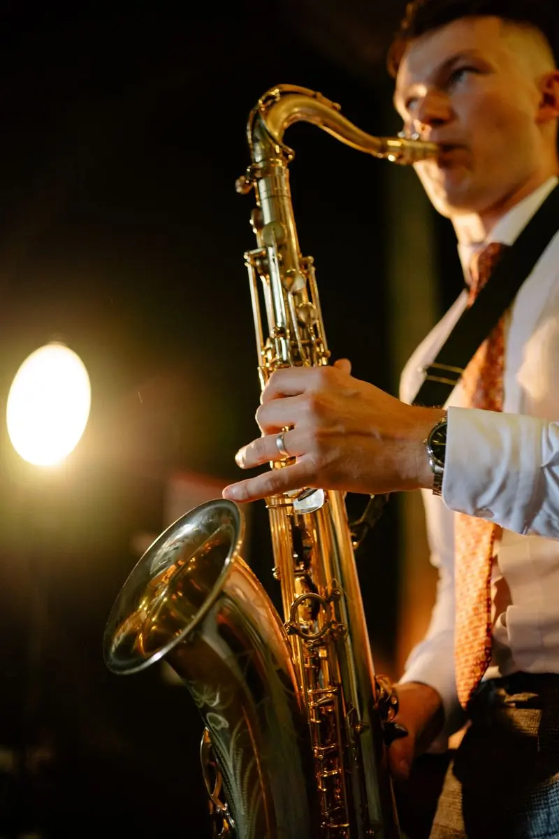 A close view of a saxophone under warm golden light