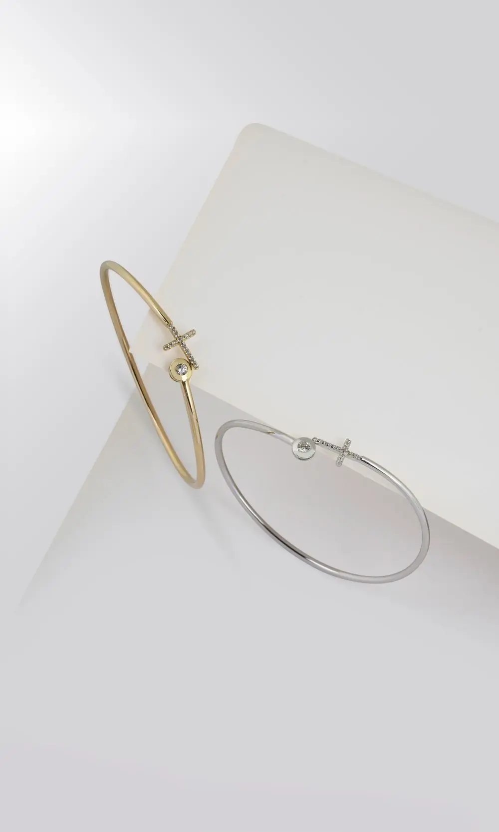 A solid cast gold bangle on a pale ground