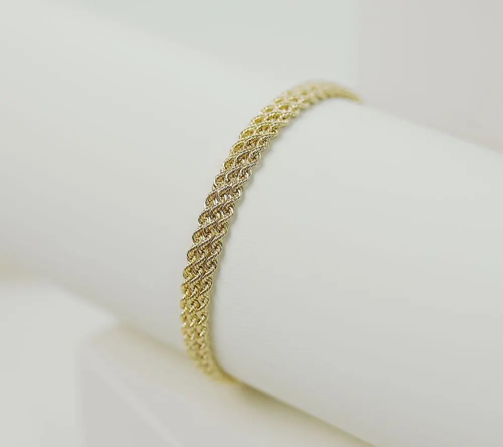 A gold chain bracelet on a white ground