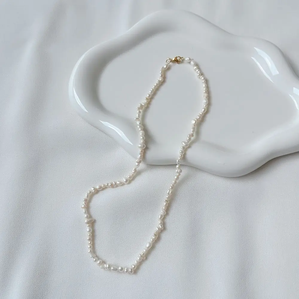 A strand of pearls on a pale ground