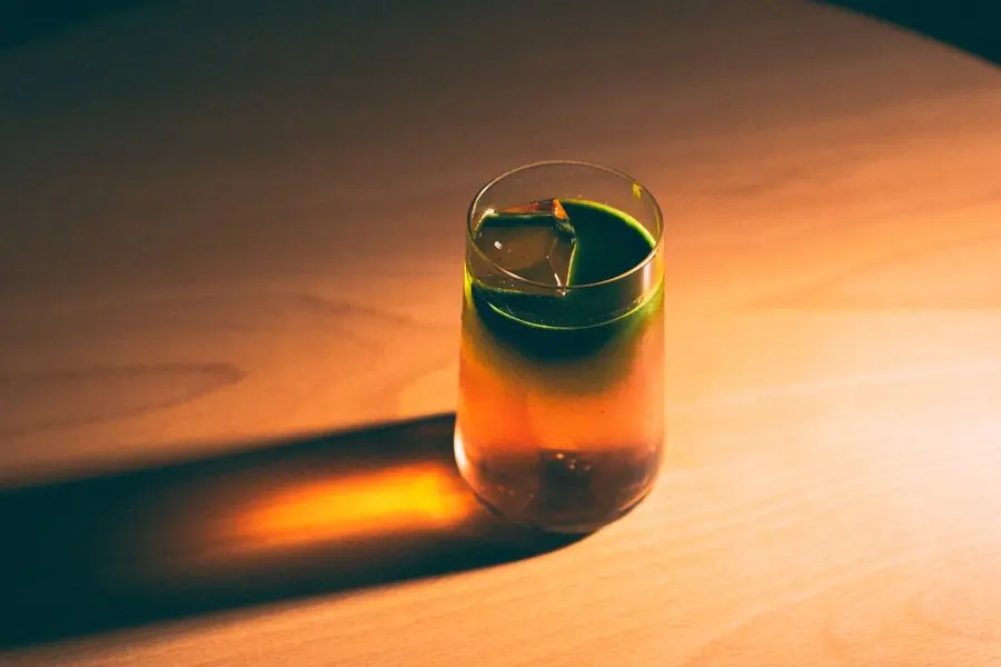 An amber cocktail on the wooden bar top