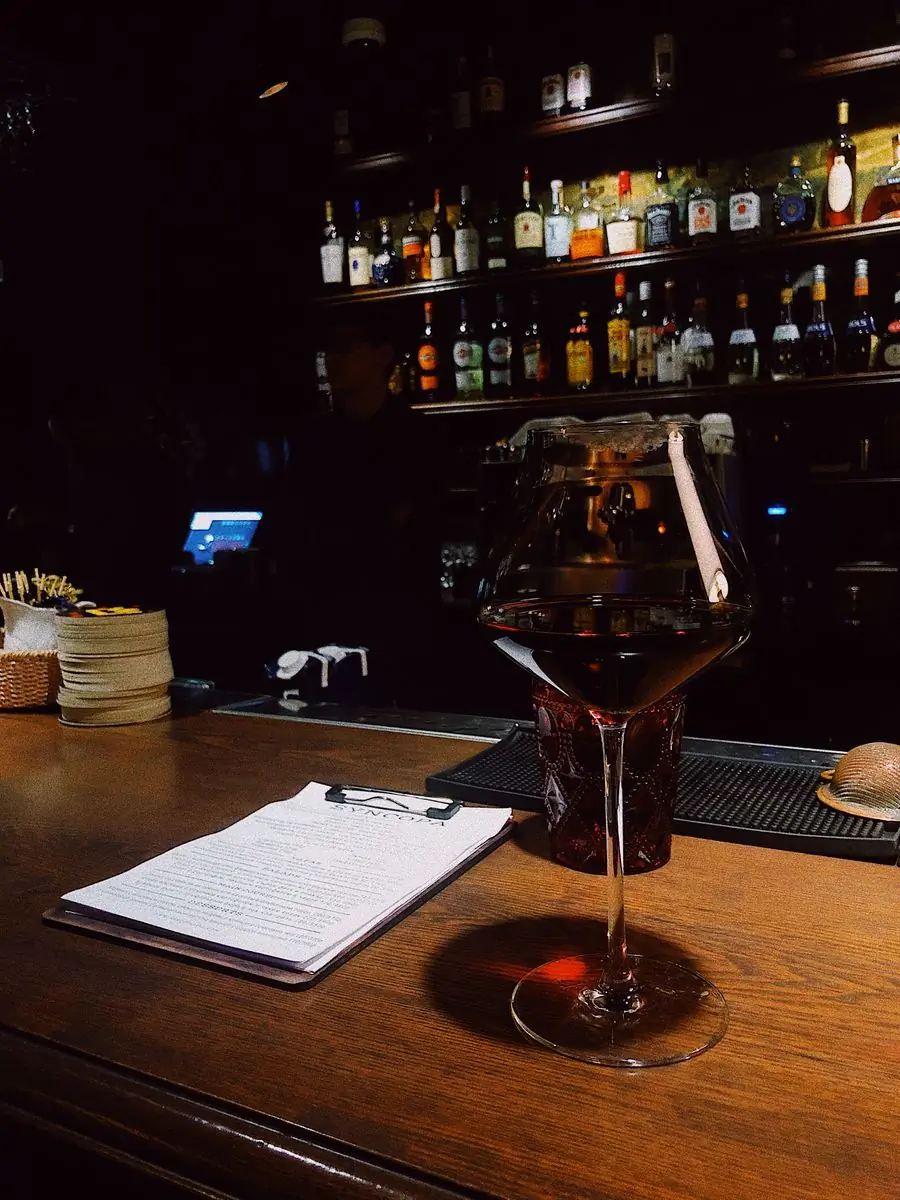 A glass of red wine on the bar counter