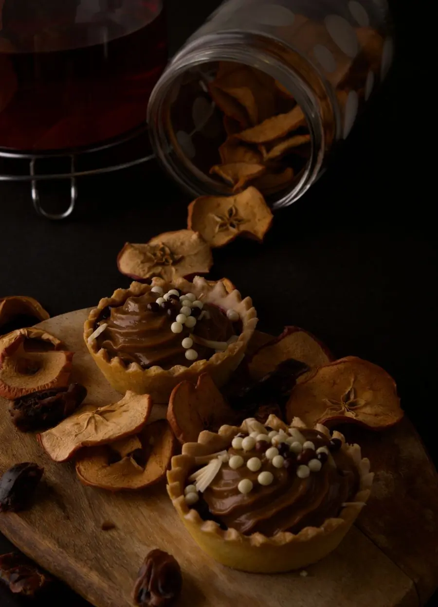 Chocolate tarts and dried fruit on slate
