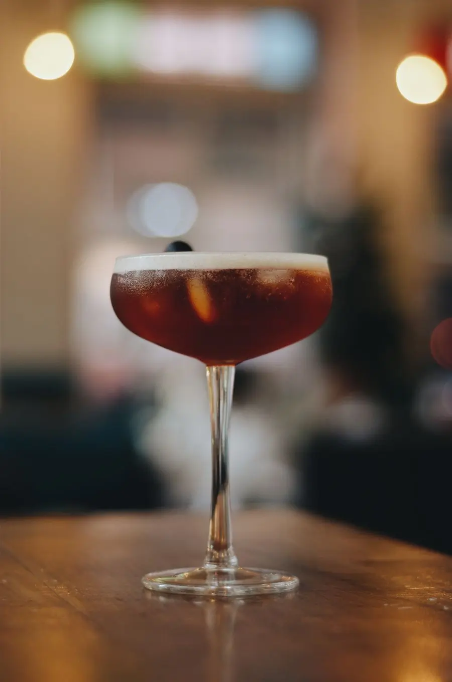 A dark stirred cocktail in a coupe