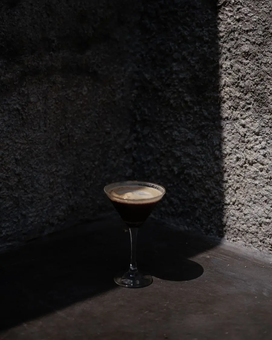A martini standing in a pool of shadow