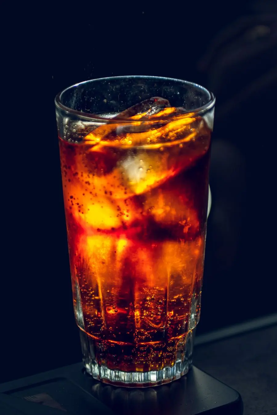A tall iced drink lit from behind