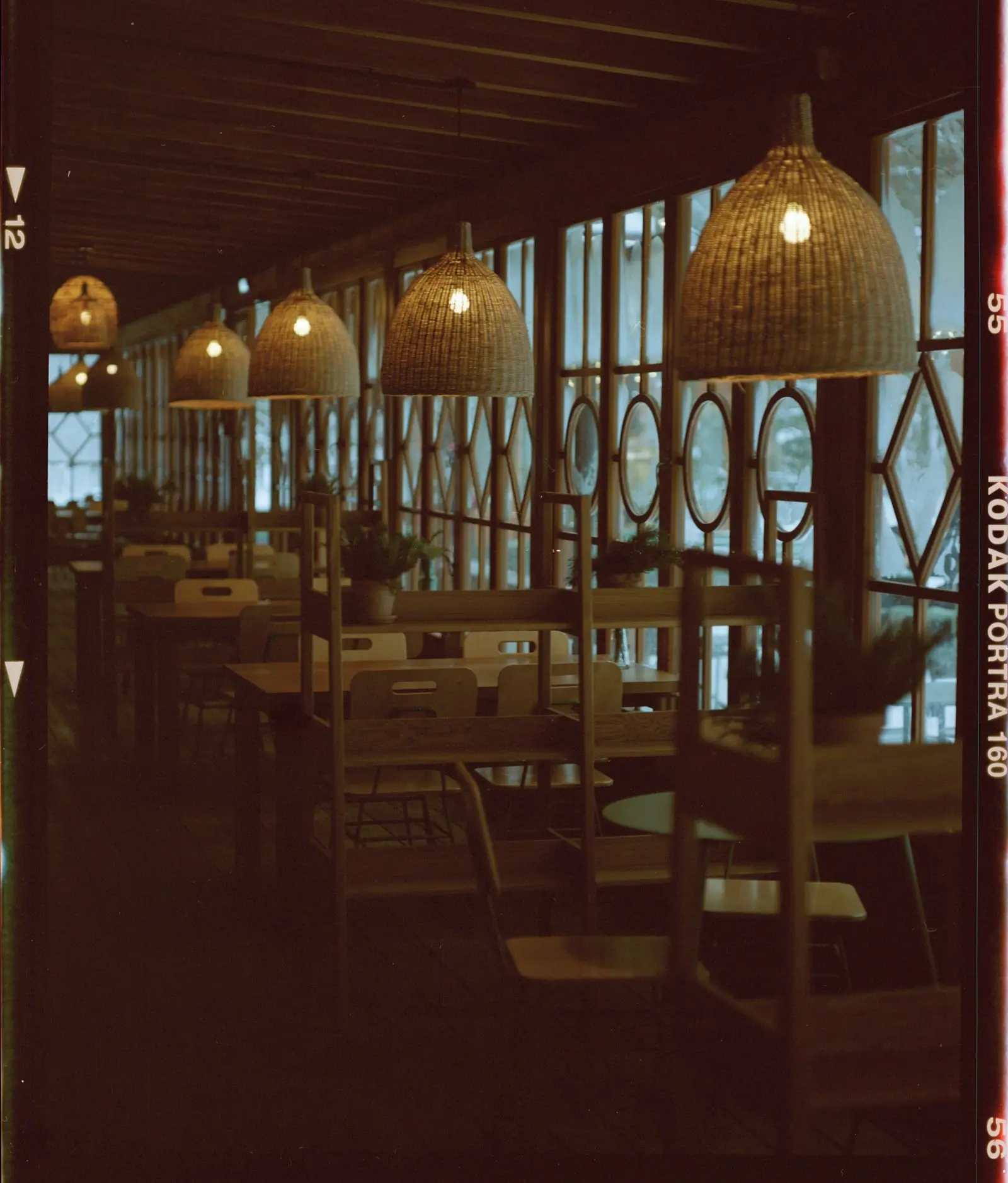 The dining room at Feast after dark, lit by the lamps over the tables