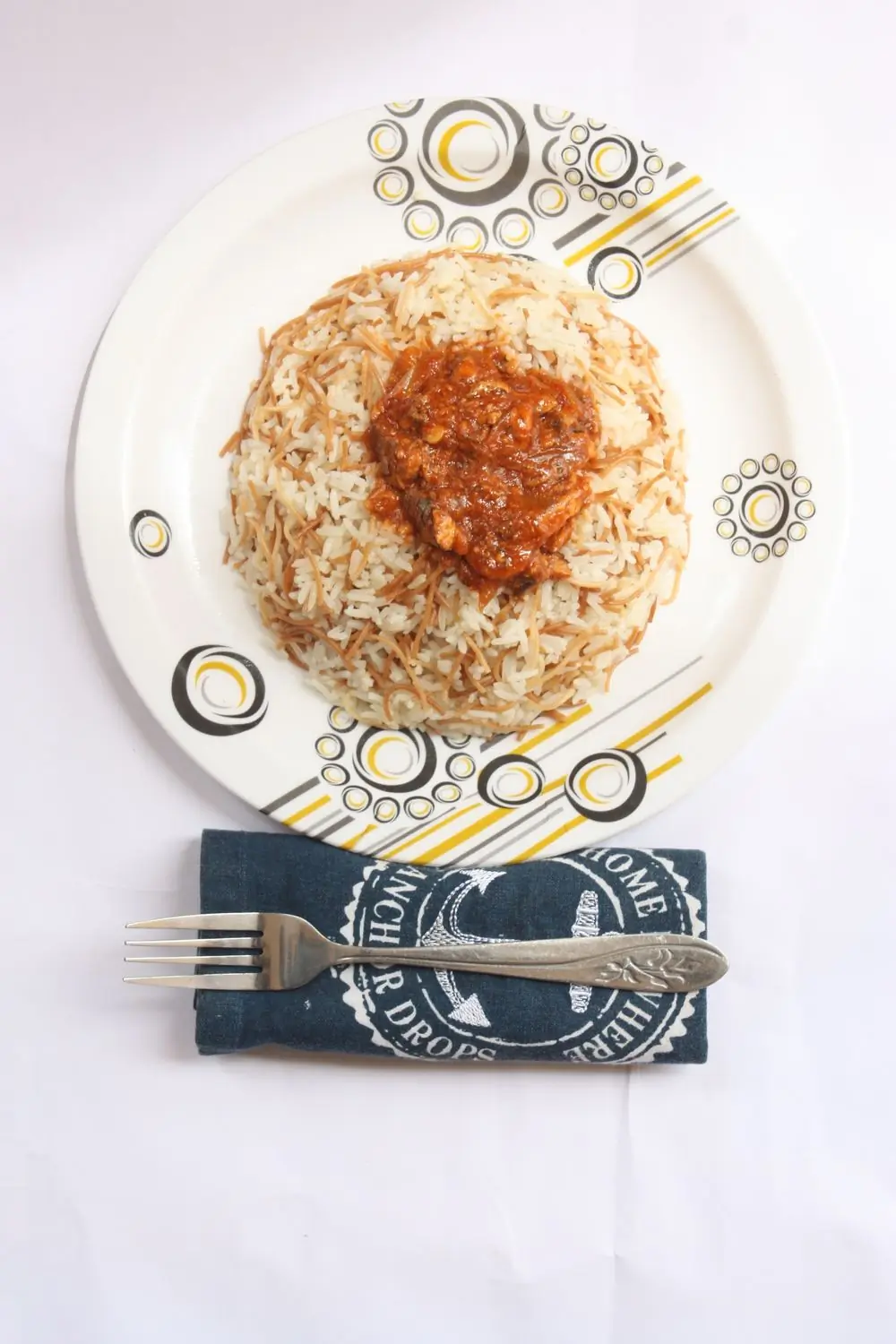 A plate of Ghanaian jollof rice with chicken