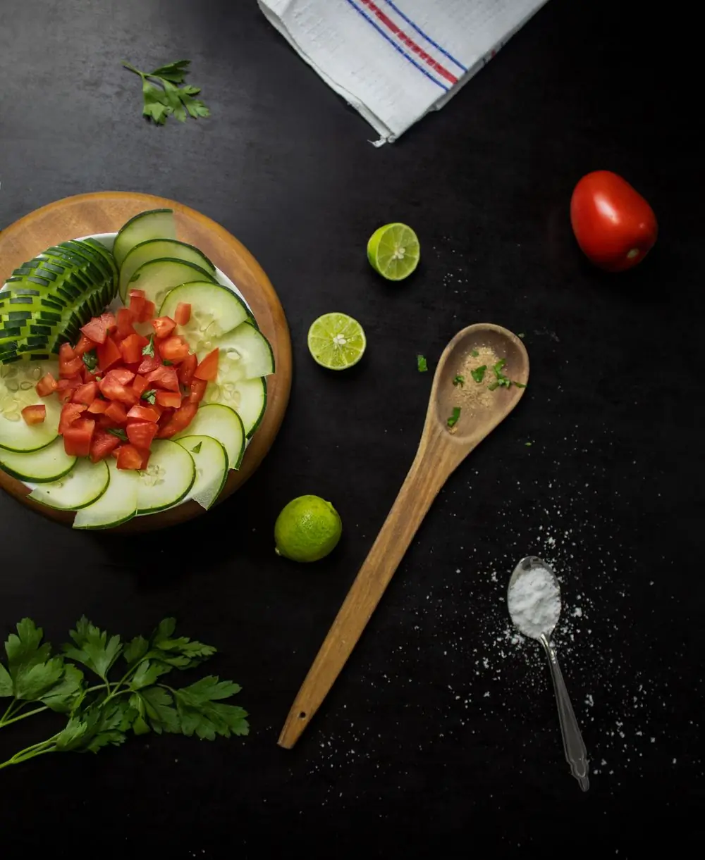 Cucumber and tomato dressed on a dark plate