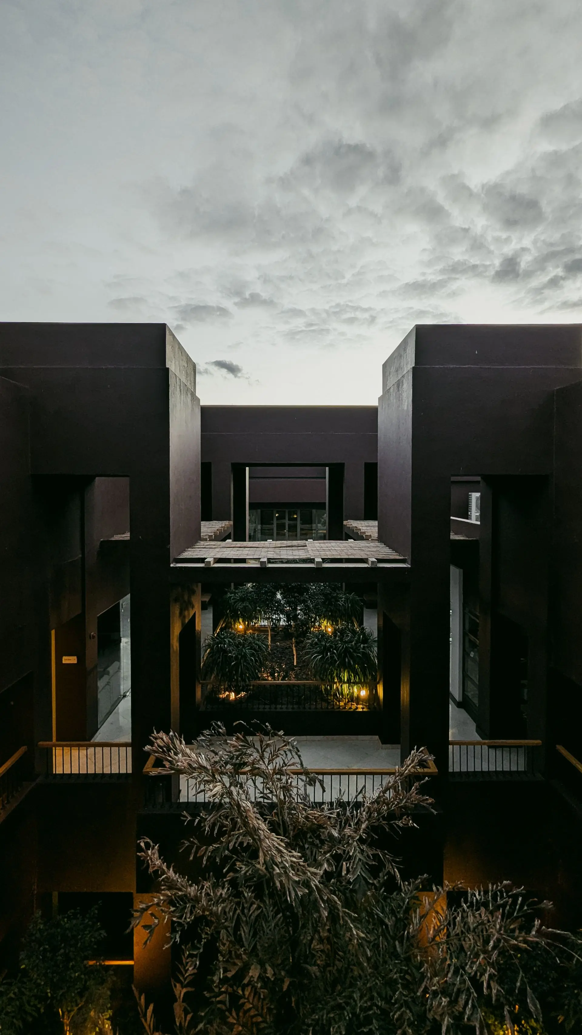 A finished building lit from within at dusk