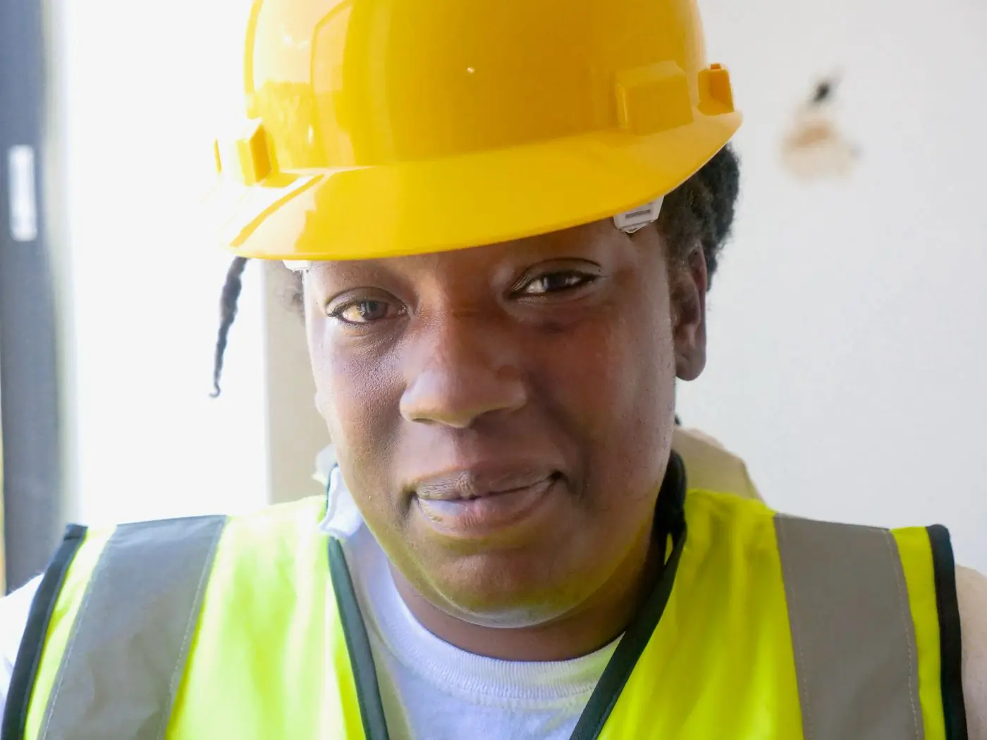 A site manager in a yellow hard hat on the deck
