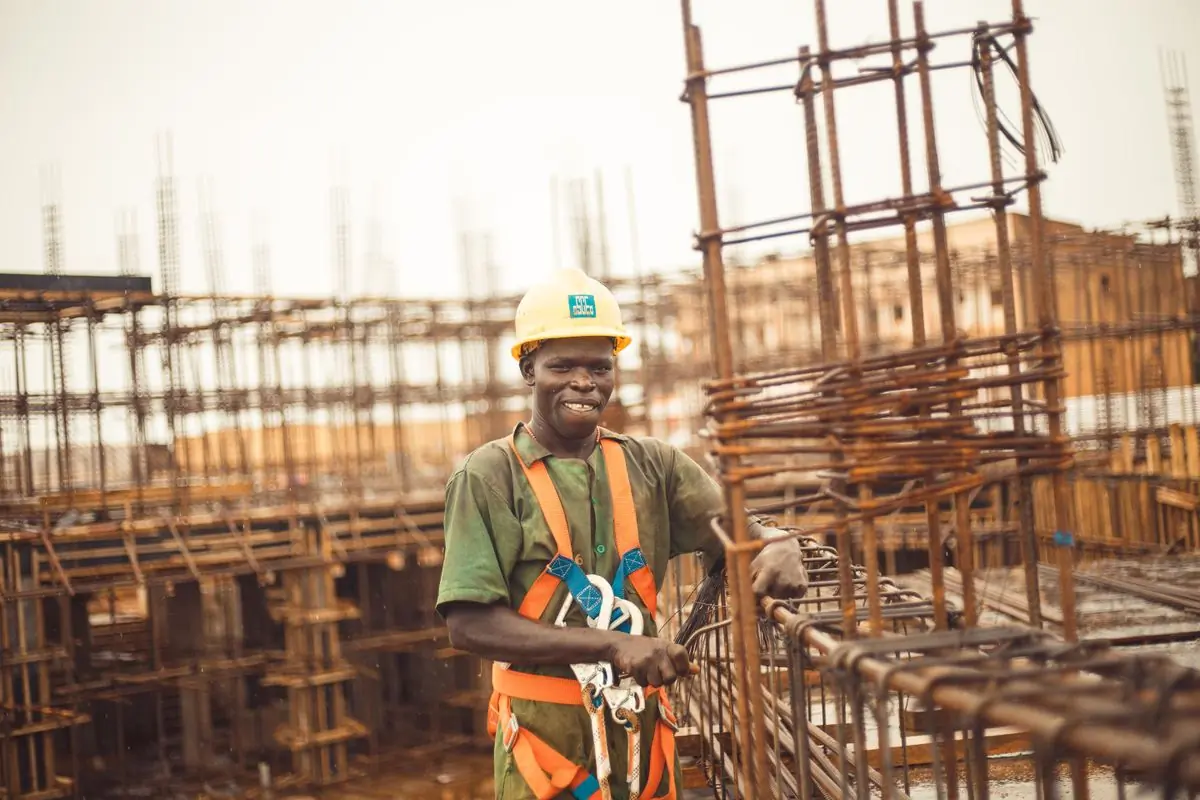A site supervisor standing in front of a reinforcement cage