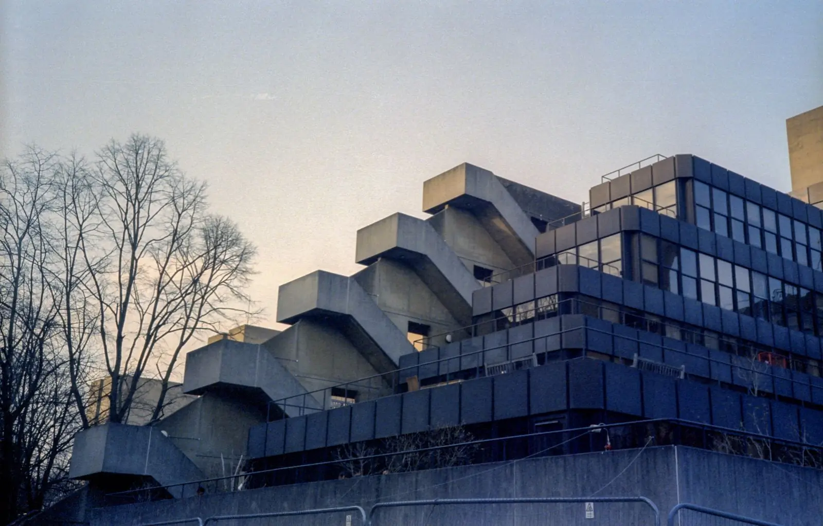 A finished concrete building standing against the evening sky