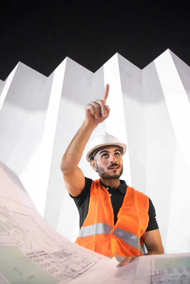 Selorm Ahiabor pointing out a detail on the structure above