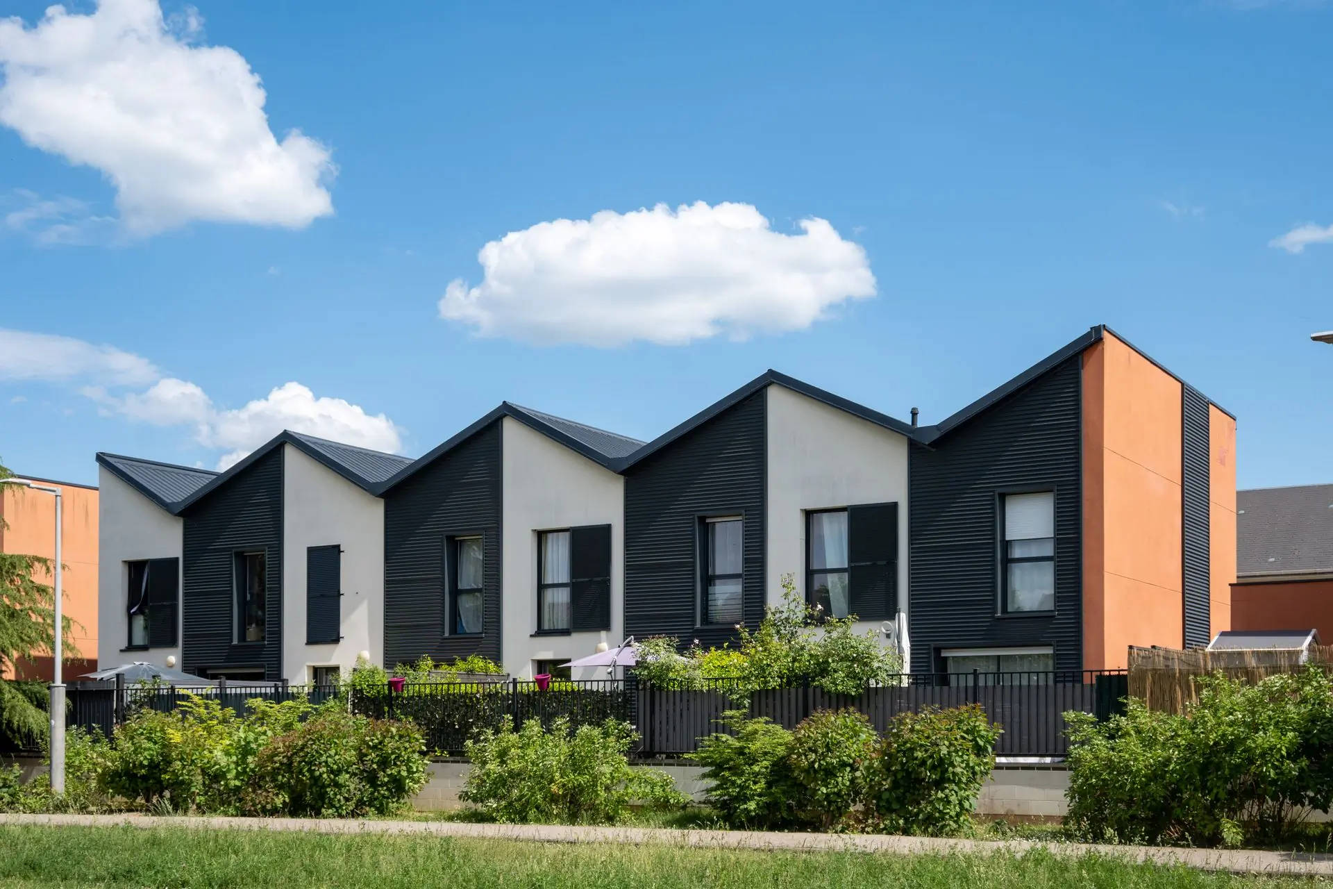 A terrace of modern homes under new standing-seam metal roofs
