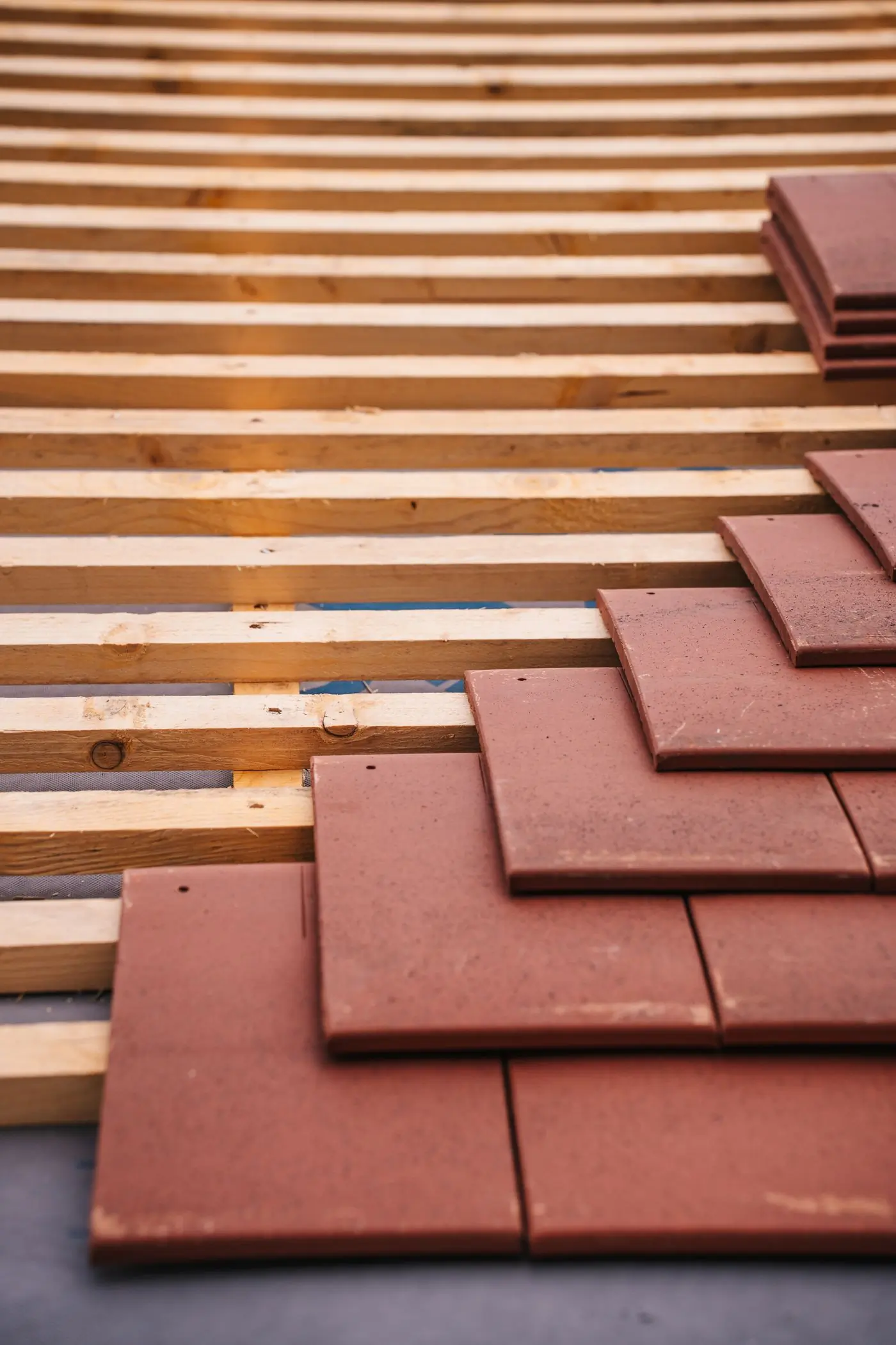 Clay tiles stacked on new battens before laying