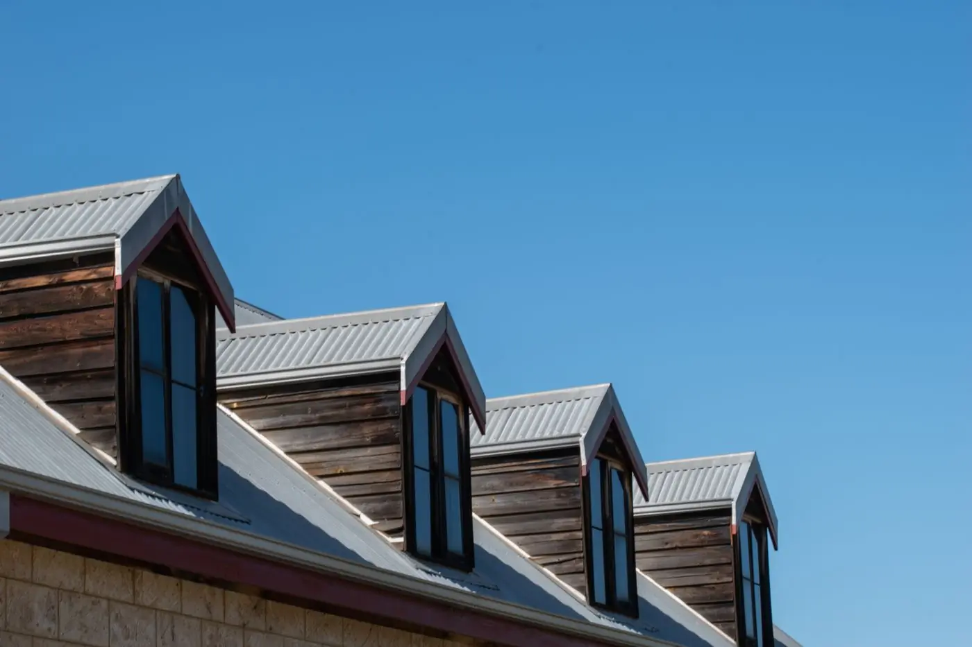 A terrace of new houses under dark standing-seam roofs