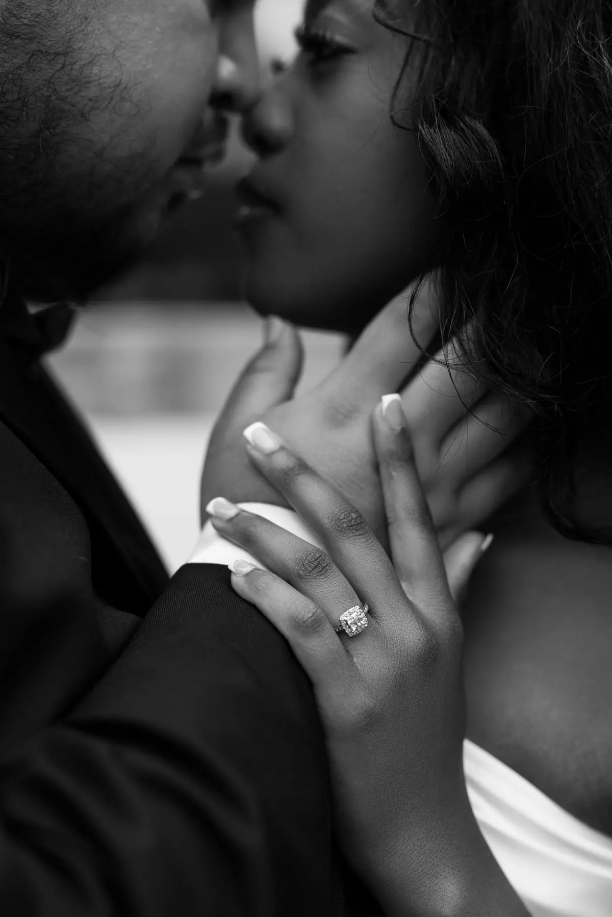 A couple holding one another closely, photographed in black and white