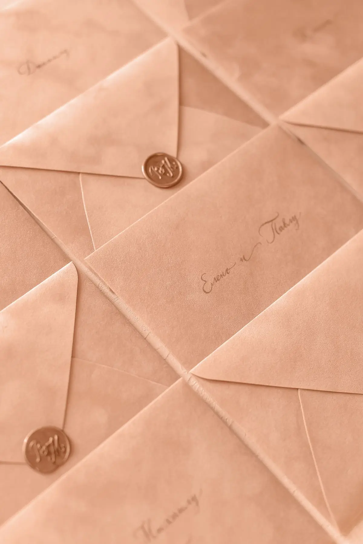 A stack of sealed envelopes with wax seals in warm light