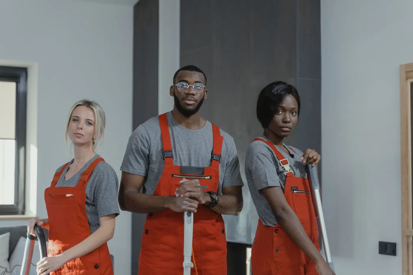 Three of the cleaning team standing together with their equipment