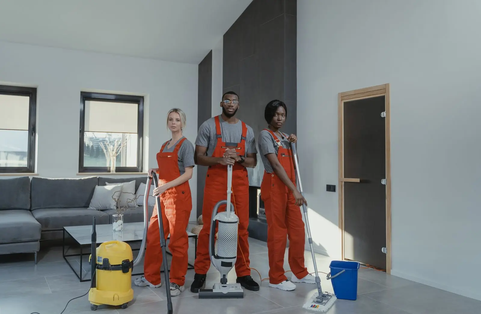 Three of the cleaning team in a customer's living room, ready to start