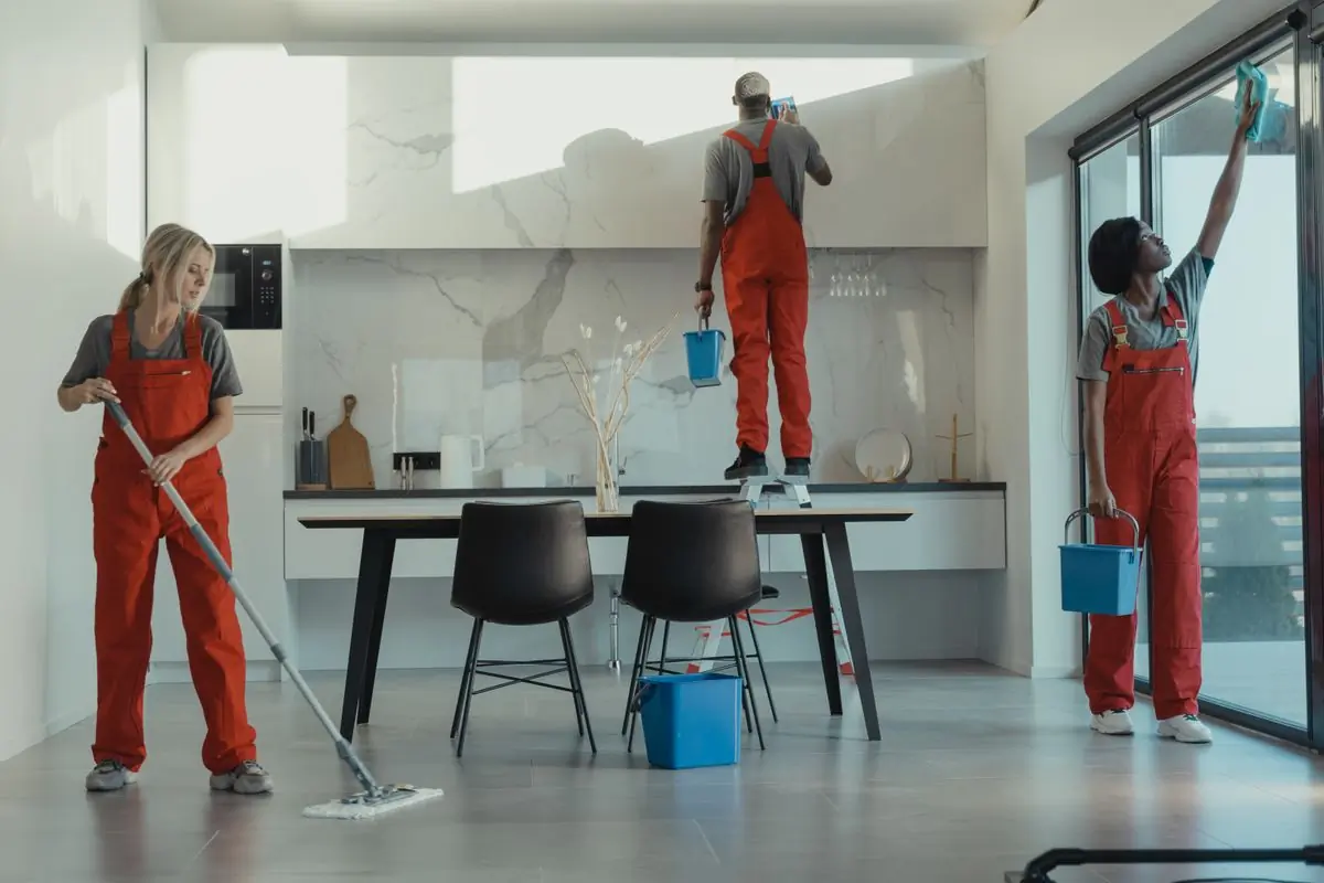 A cleaning team working through a modern open-plan office