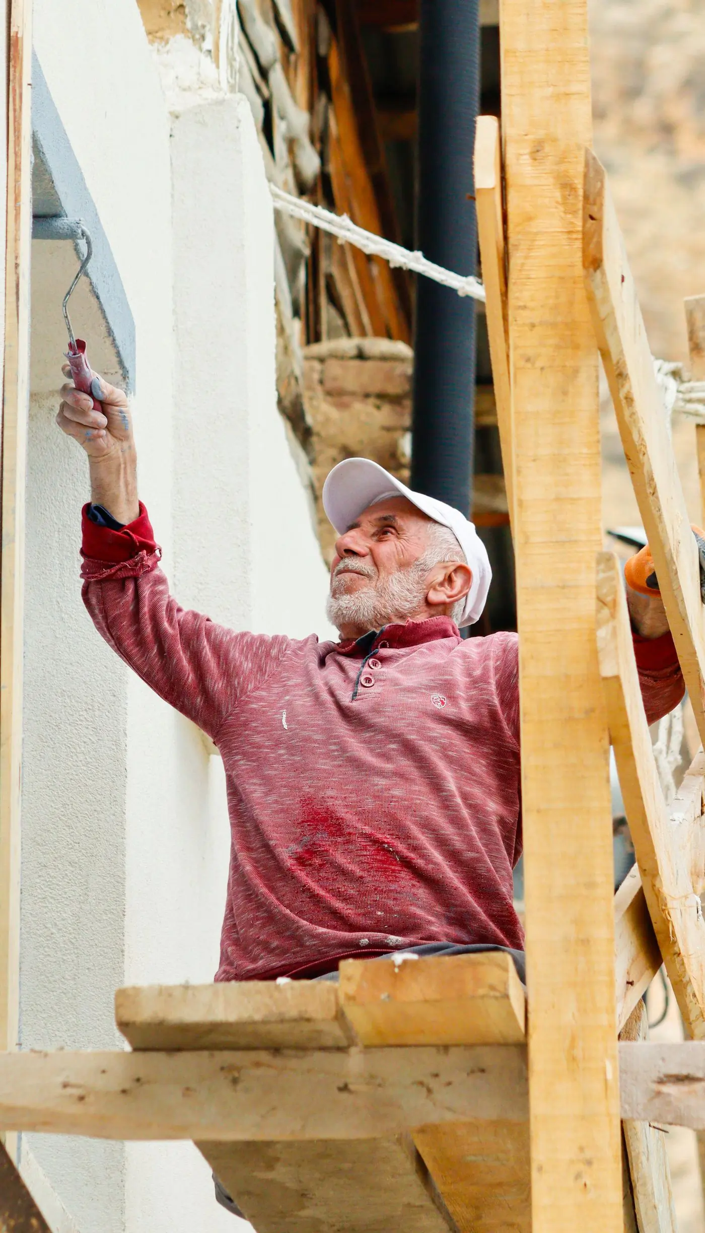 One of the firm's decorators cutting in along a rendered exterior wall