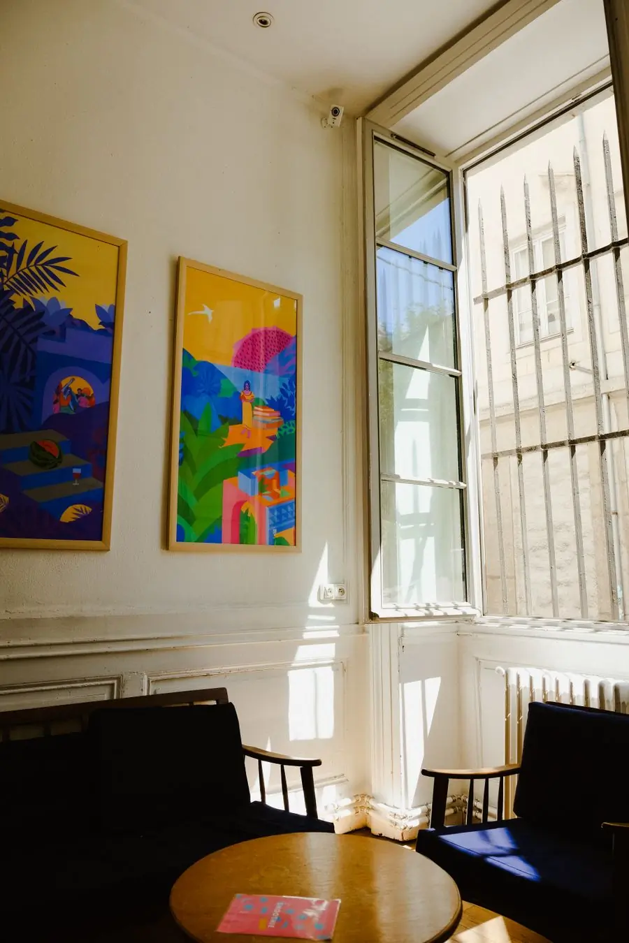 Two large colour-field canvases on a tall pale wall