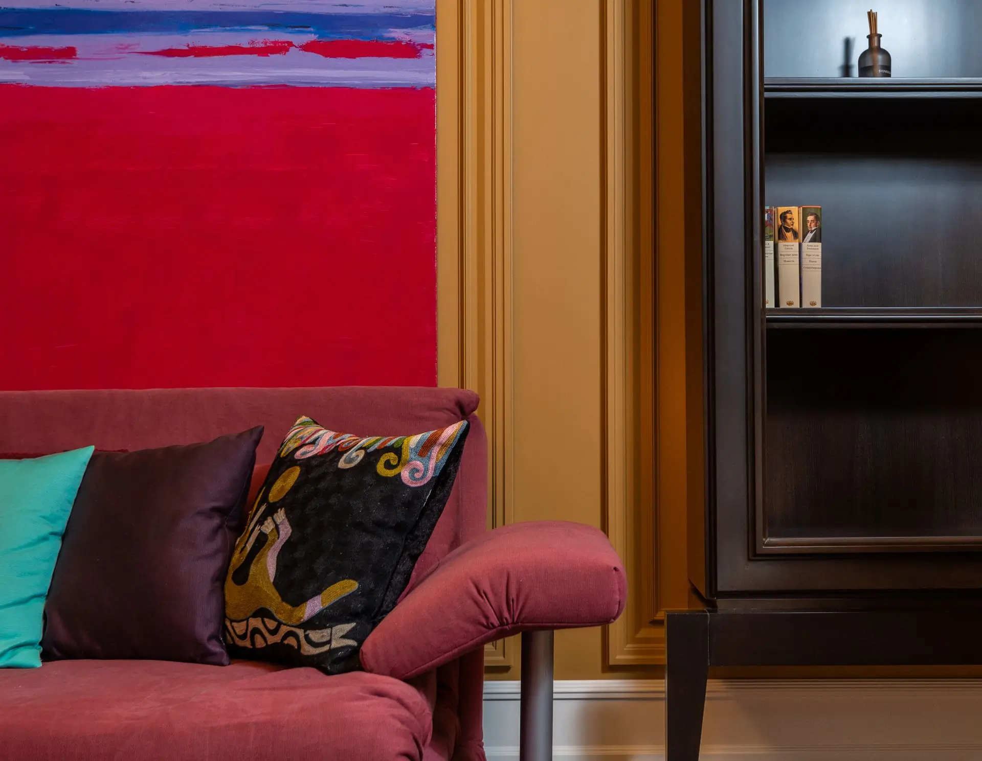 A crimson drawing room finished by the firm