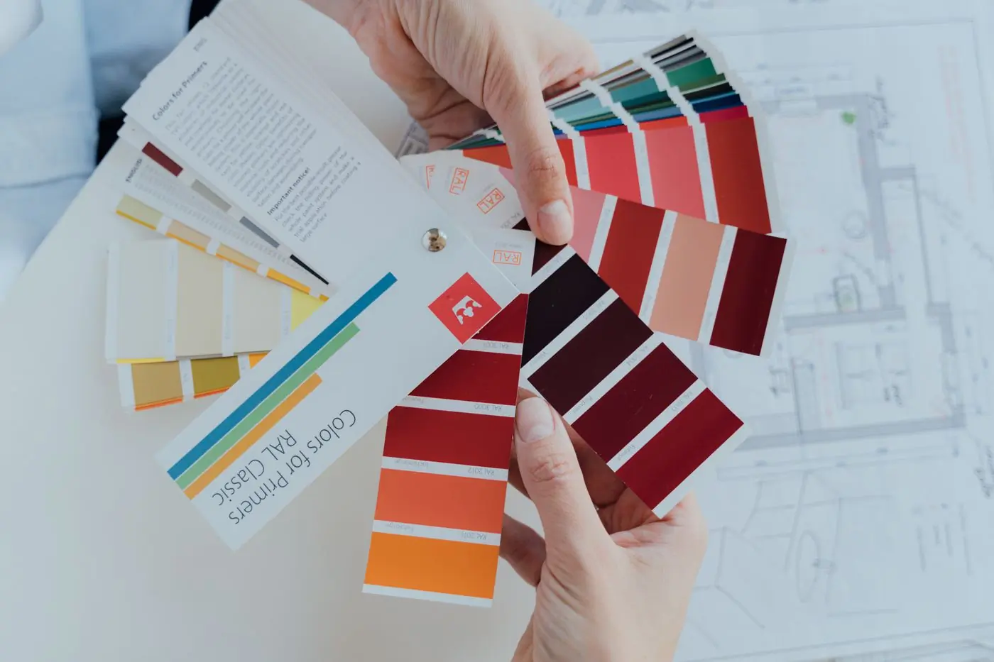 Colour cards and a floor plan spread out during a consultation