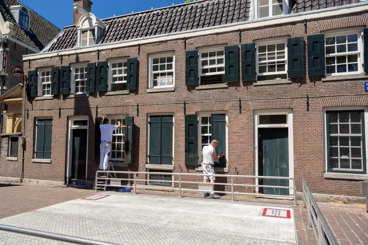 A terrace of houses with their shutters and frames freshly painted