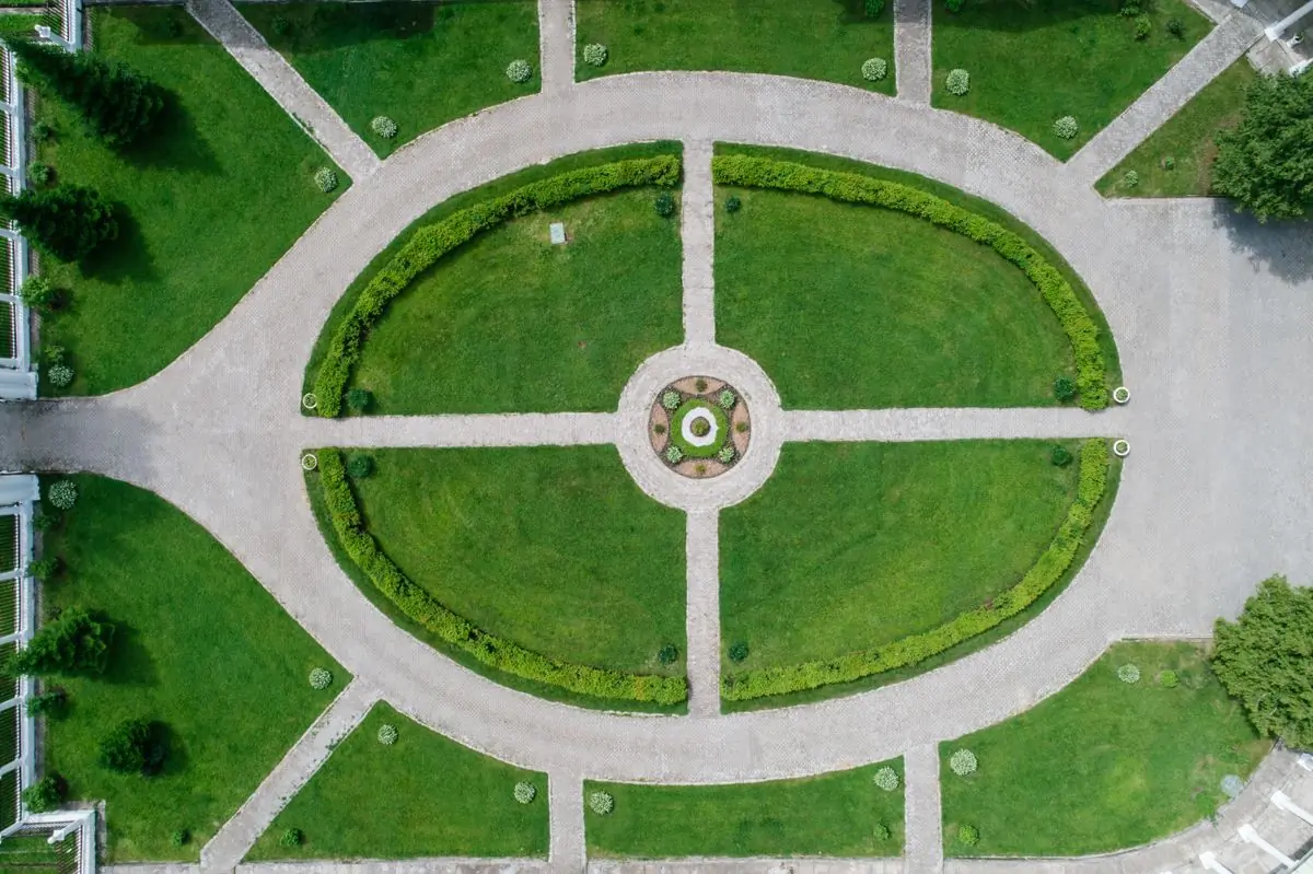 A formal parterre garden seen from above, its paths and lawns laid out symmetrically