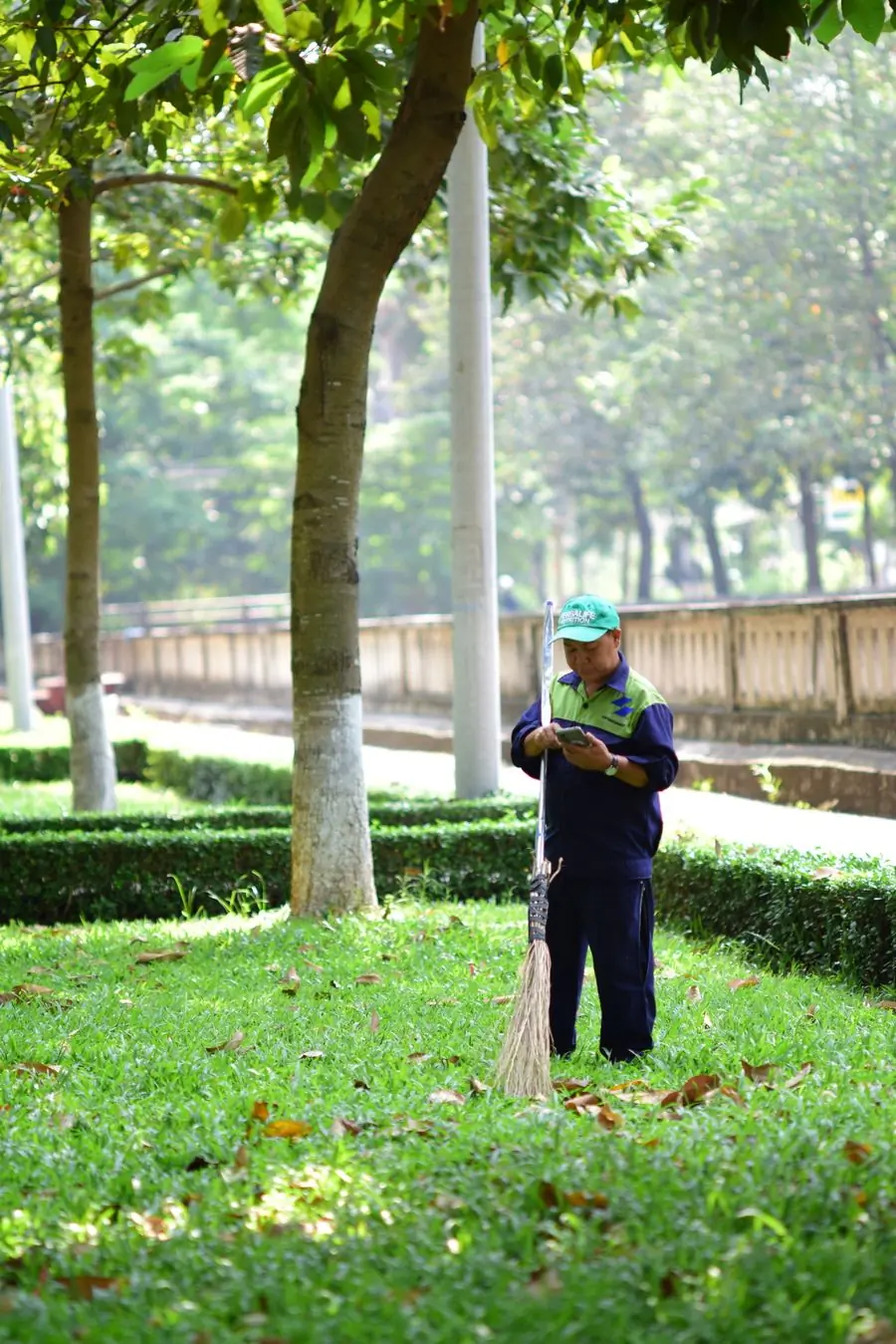 A gardener walking a client's grounds with a clipboard