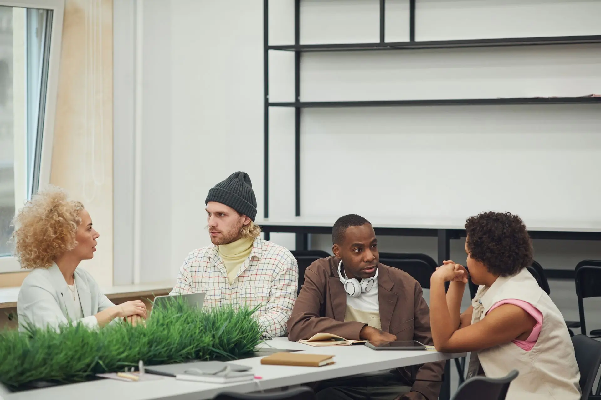 Colleagues talking around a table in a bright office