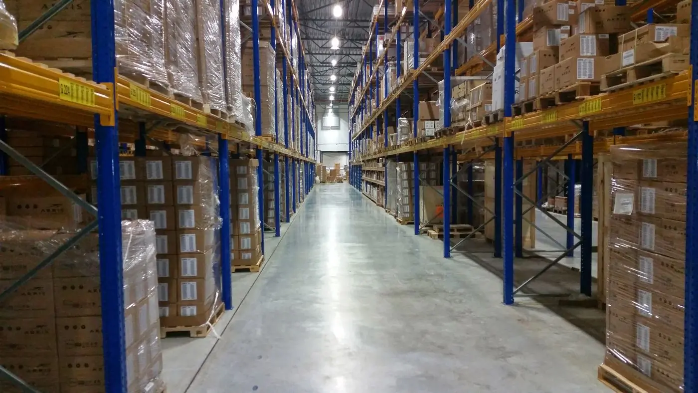 A clean warehouse aisle with racking stacked with cartons