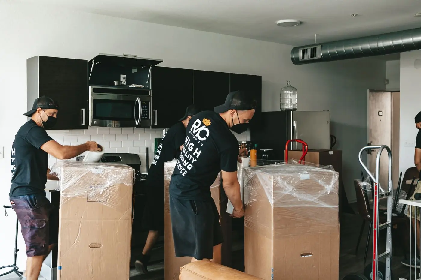 A crew unpacking cartons into a newly fitted room