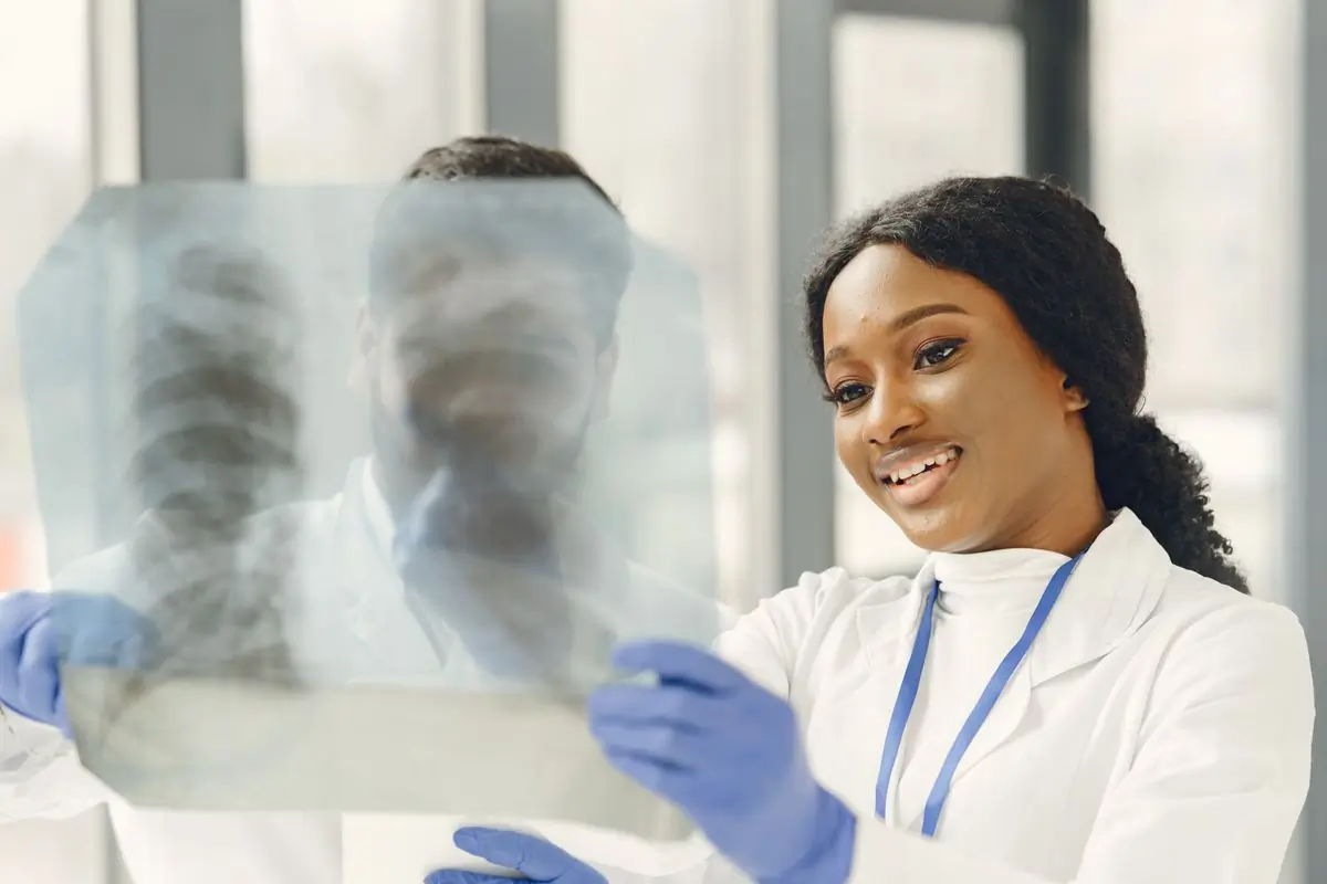 A radiologist reading a chest film in the imaging department
