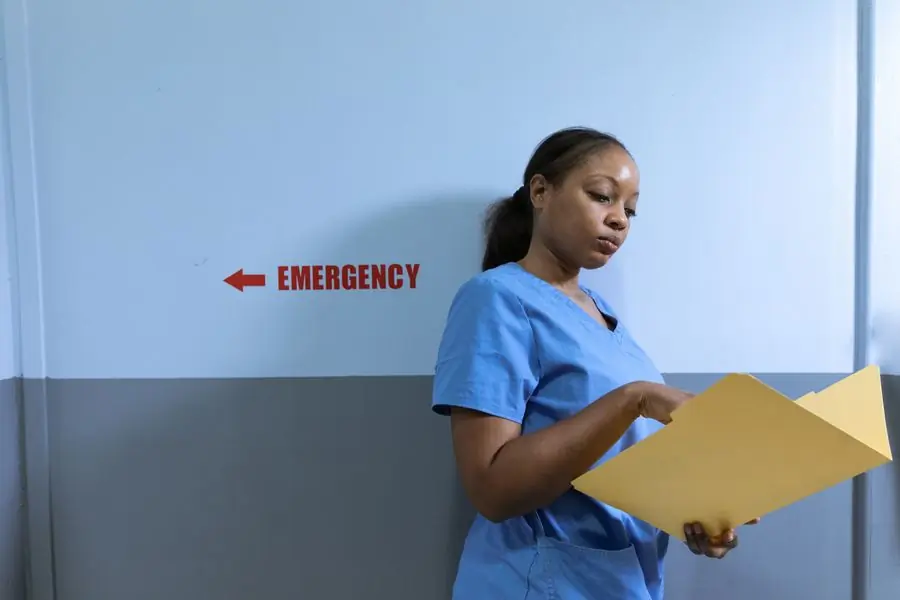 A nurse reading notes outside the hospital's emergency department