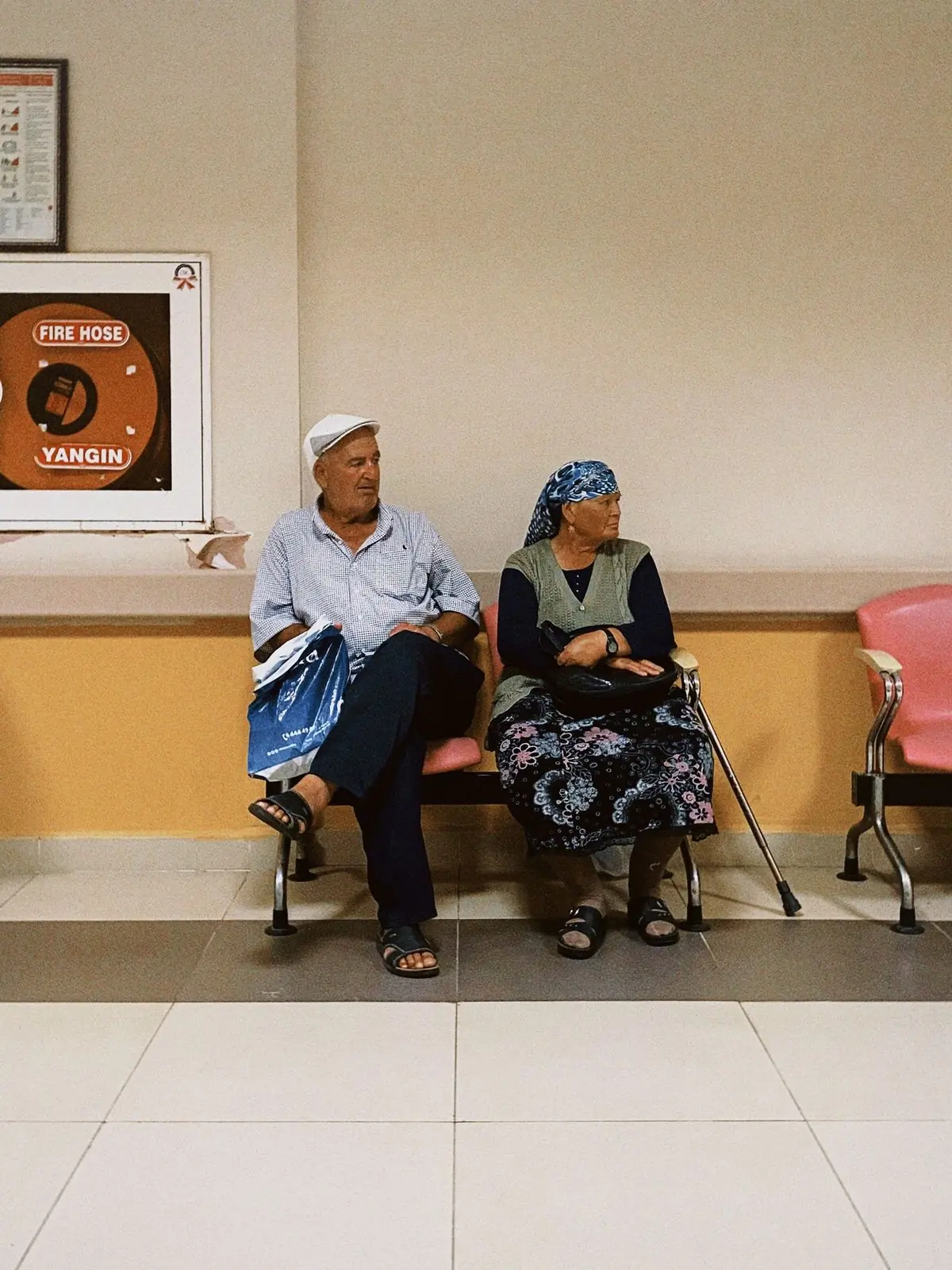 A couple waiting together in the hospital's outpatient corridor