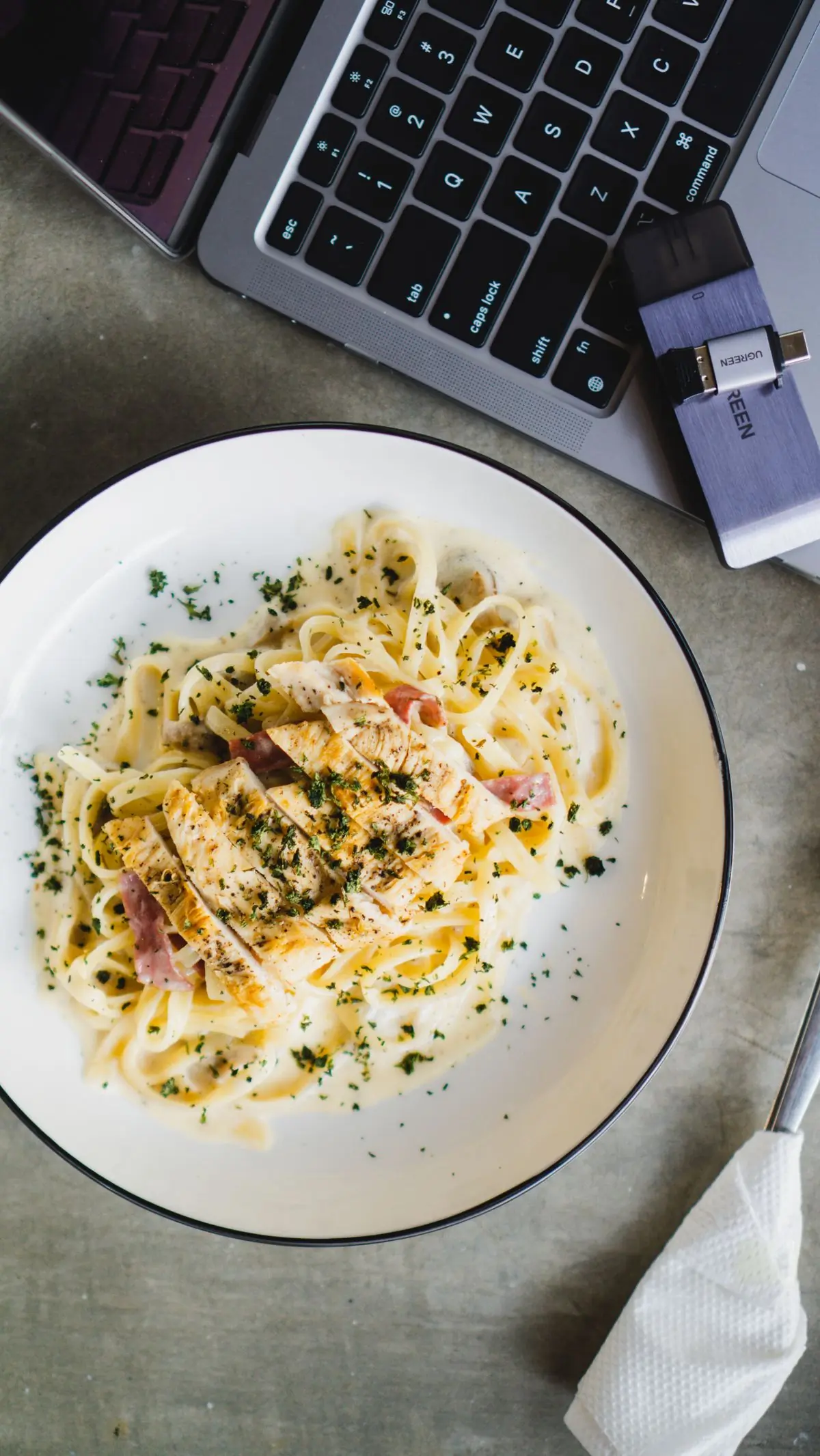 Creamy alfredo pasta with chicken in a white bowl