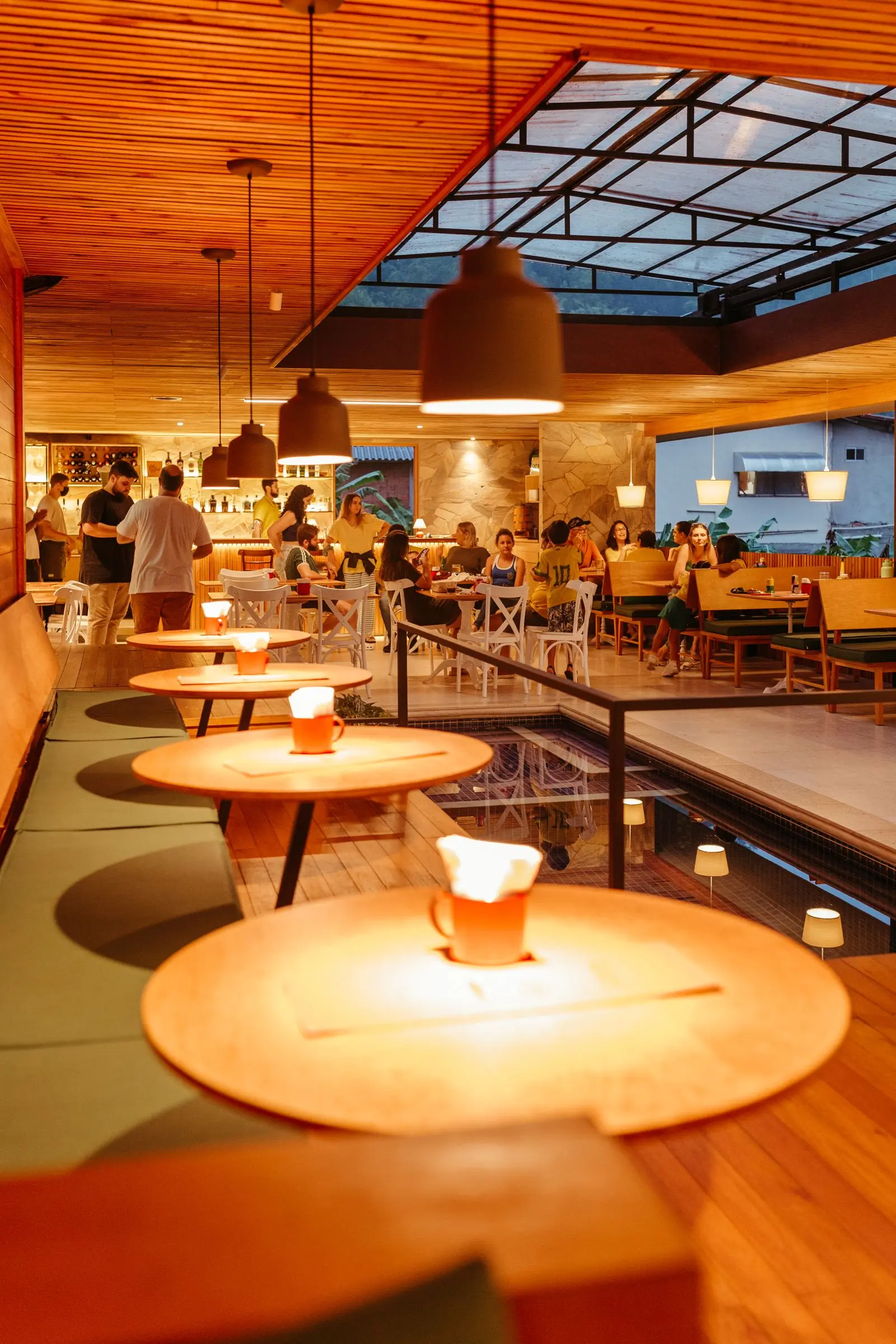 The dining room at Hearth in the evening, lit by the lamps over the tables