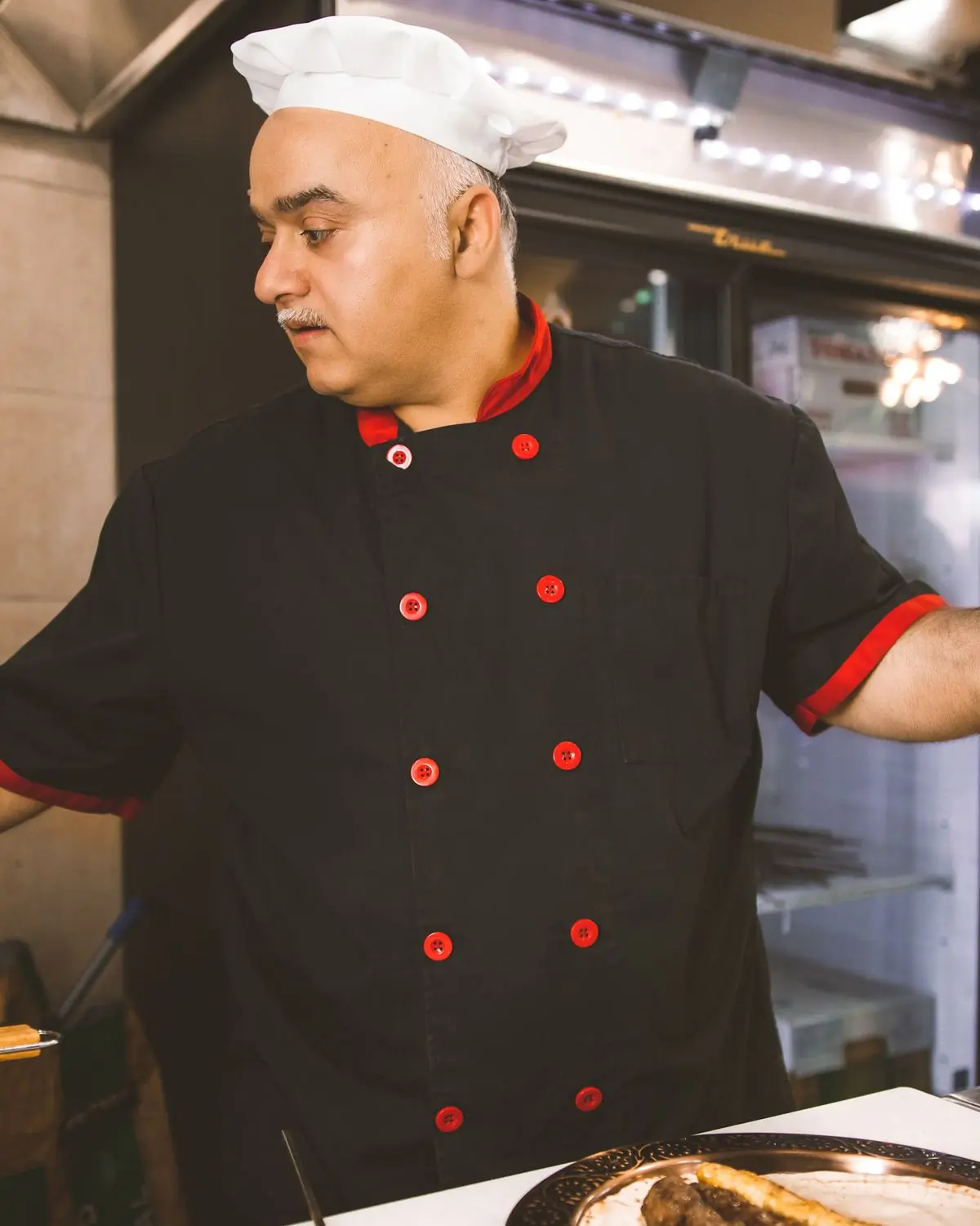 A chef working the line in the kitchen at Hearth