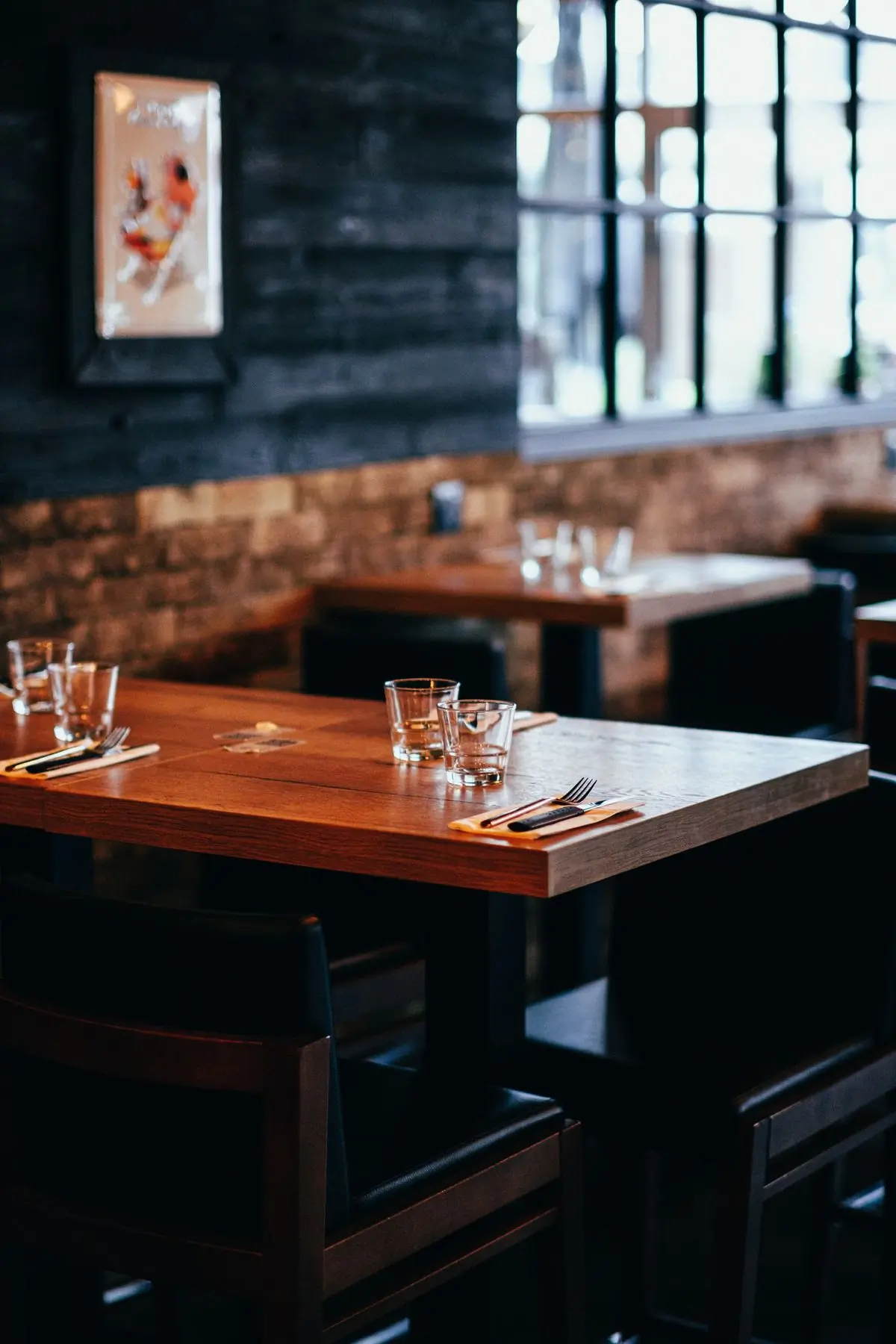 Glassware laid out on a worn wooden table in the dining room